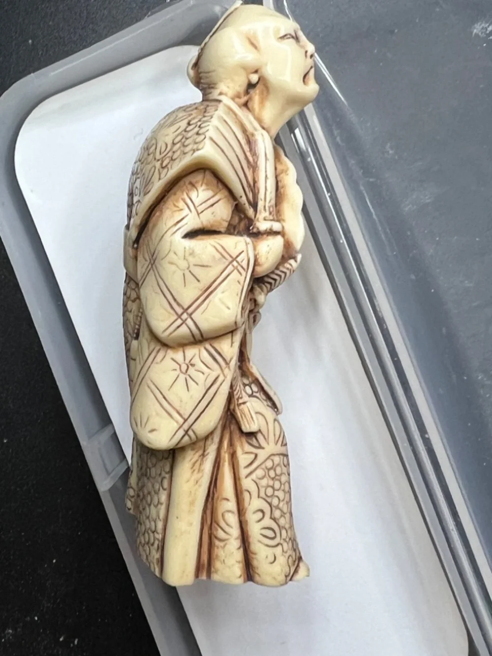 Hand-carved Japanese figurine likely a samurai or similar figure